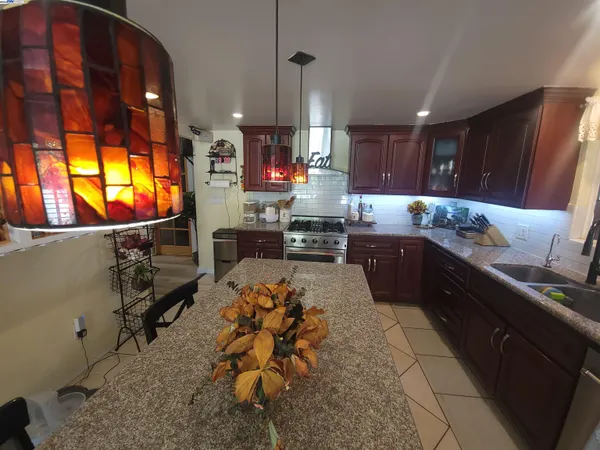 a kitchen with stainless steel appliances granite countertop sink stove and cabinets