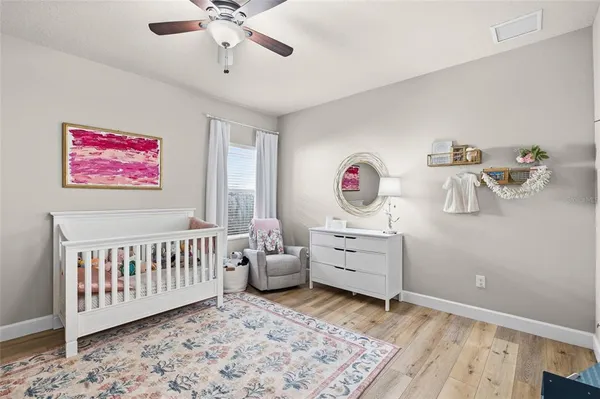 a bedroom with furniture and a large window