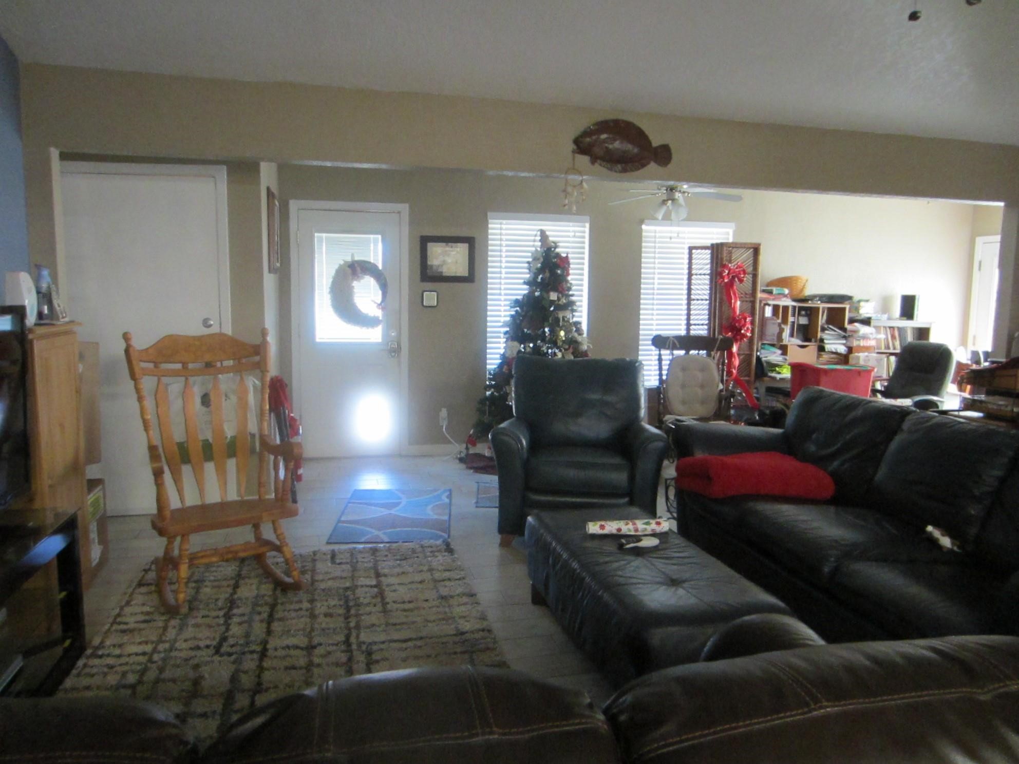 314 Shark Lane Surfside Beach, TX 77541 - Photo 3 of 12 a living room with furniture and a chandelier