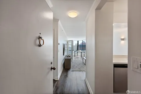 a view of a hallway with wooden floor and staircase
