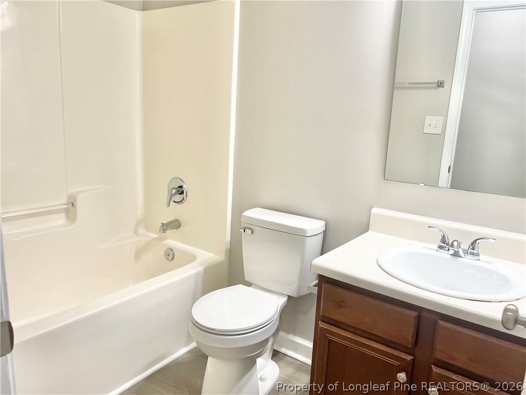 1523 Rough Rider Lane Parkton, NC 28371 - Photo 42 of 42 a bathroom with a sink a toilet and bathtub