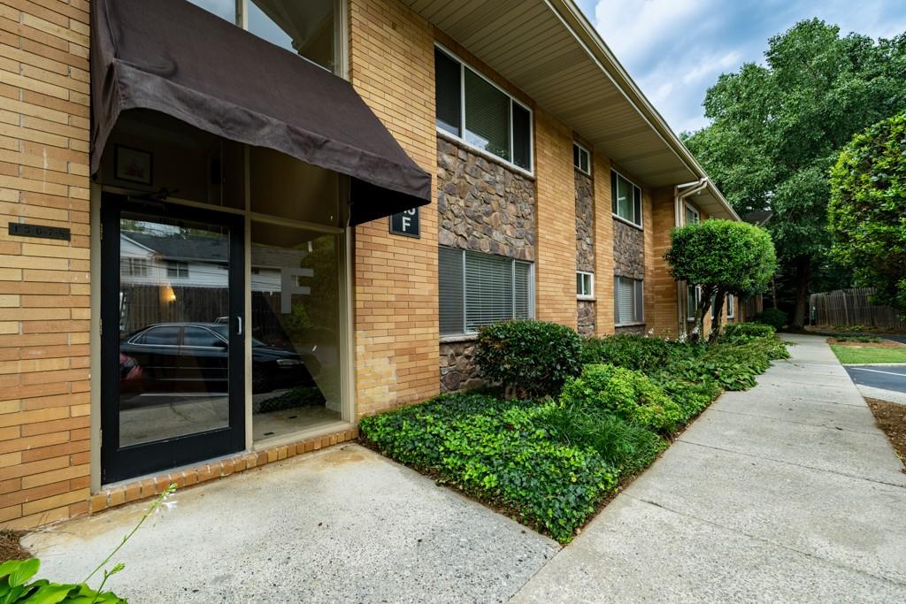 115 Biscayne Drive Northwest, Unit F6 Atlanta, GA 30309 - Photo 1 of 30 a view of a house with a yard