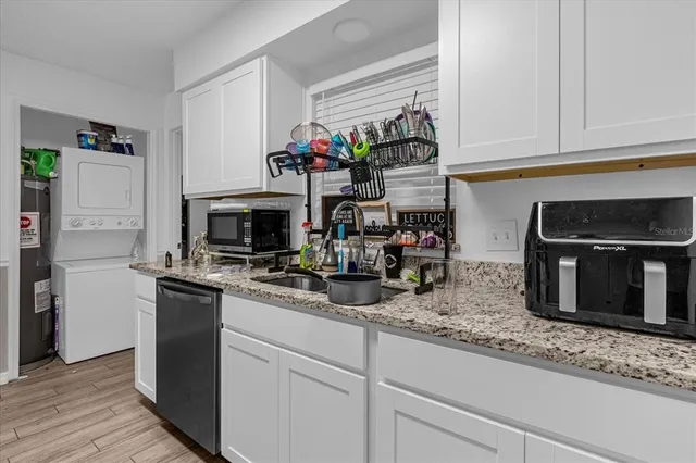 a kitchen with appliances a sink and cabinets