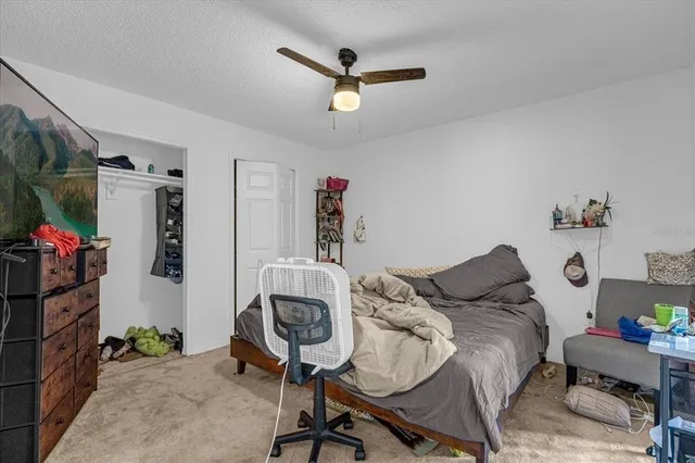 a bedroom with a bed a desk and chair