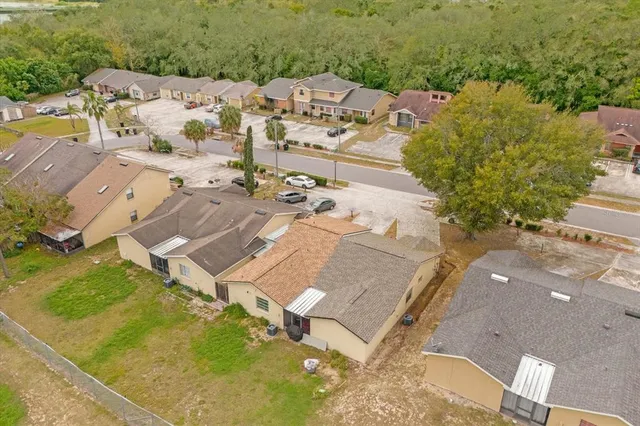 an aerial view of residential houses with outdoor space