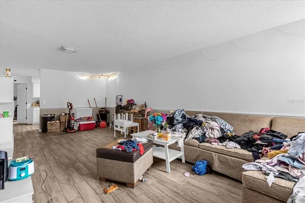 a living room with lots of furniture and a wooden floor