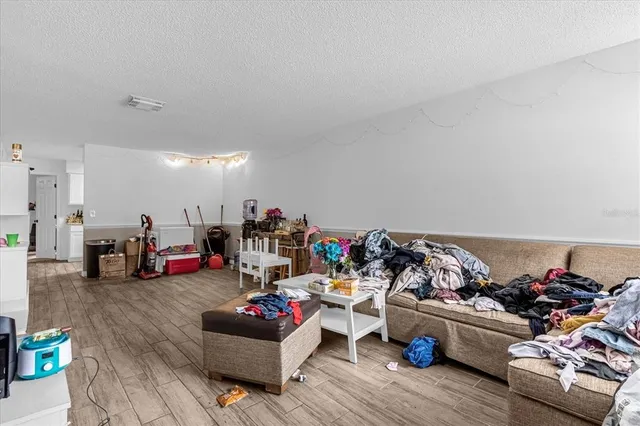 a living room with lots of furniture and a wooden floor