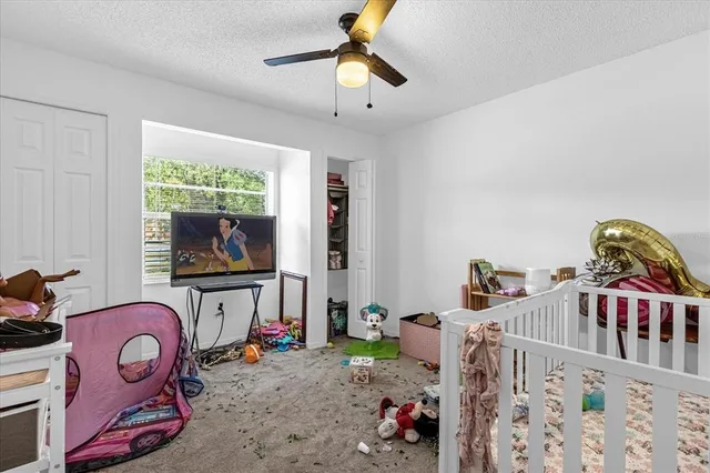a bedroom with furniture and a flat tv screen