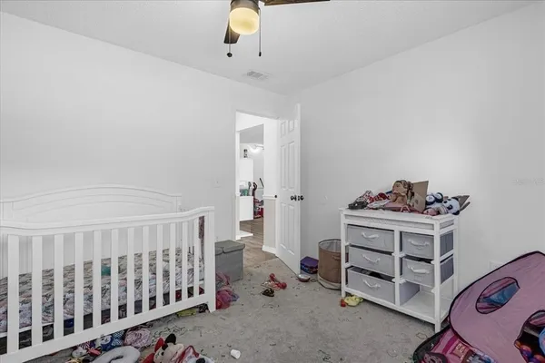 a bedroom with a bed and white walls