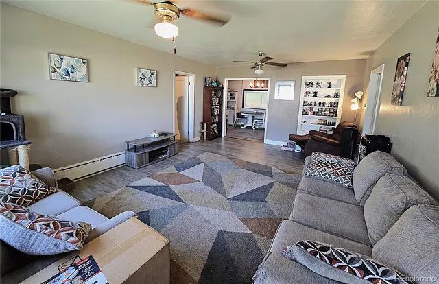 a living room with furniture and wooden floor