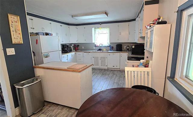 a kitchen with a refrigerator a stove top oven and a refrigerator