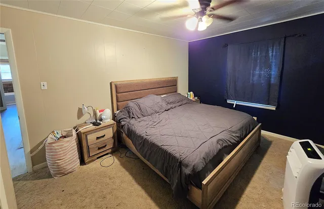 a bedroom with bed and a chandelier