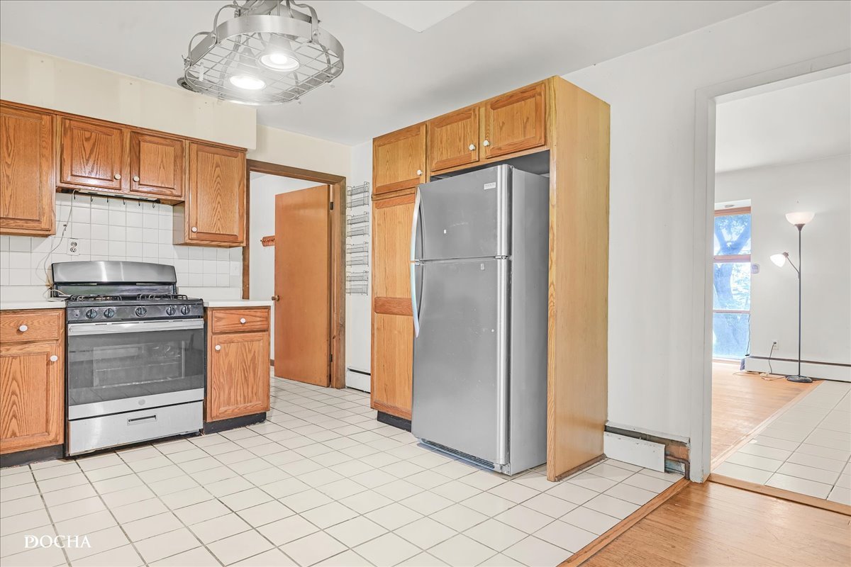 1218 North Randall Road Aurora, IL 60506 - Photo 10 of 24 a kitchen with stainless steel appliances a refrigerator and a stove top oven
