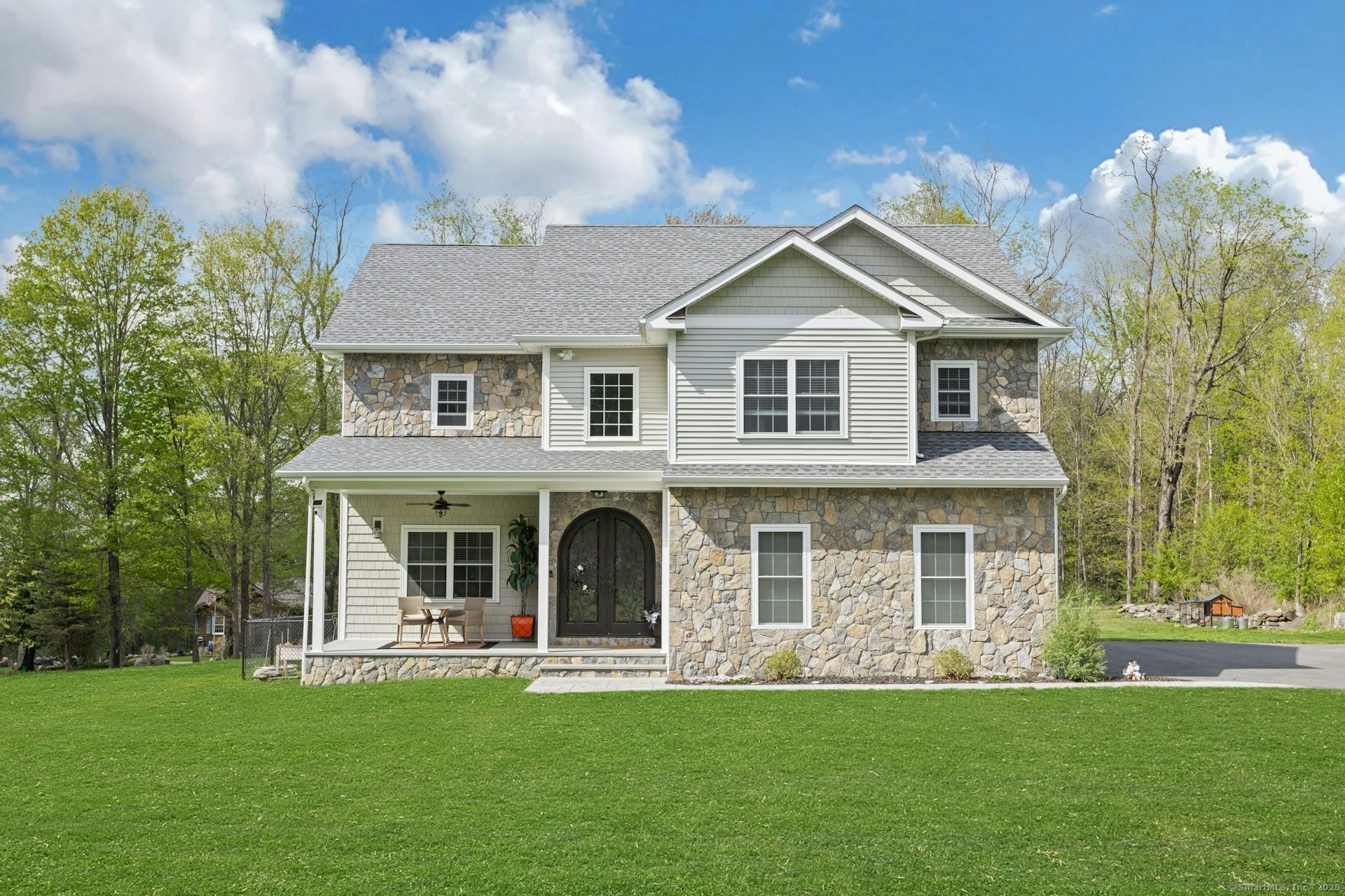 13 Wanzer Hill Road Sherman, CT 06784 - Photo 1 of 1 a front view of a house with a garden and patio