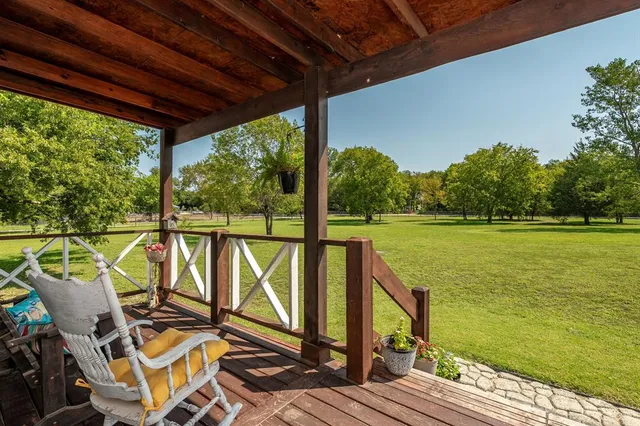 a view of a balcony with lake view and wooden floor