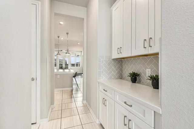 a kitchen with white cabinets