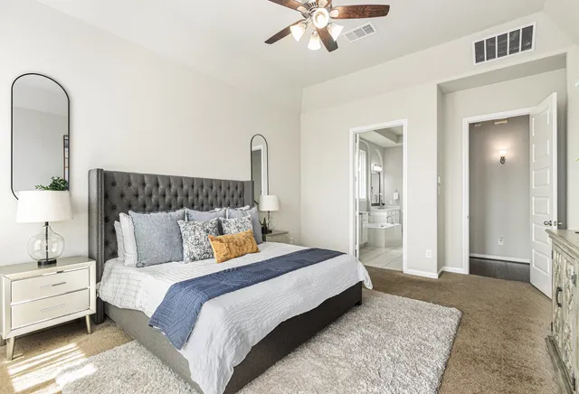 a bedroom with a bed and a chandelier