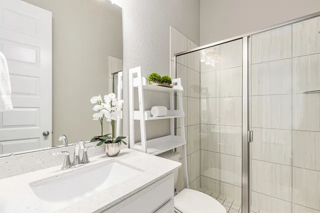 a bathroom with a sink toilet and shower