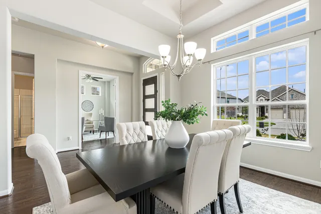 a view of a dining room with furniture wooden floor and chandelier