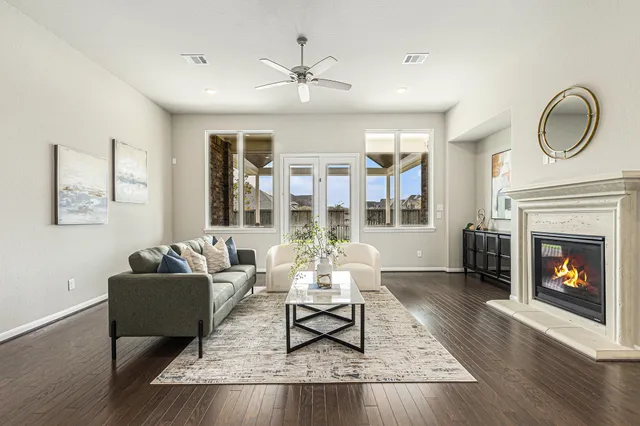 a living room with furniture fireplace and window