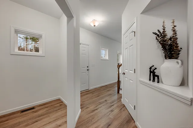 a view of hallway with wooden floor