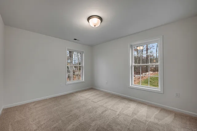 an empty room with closet area and mirrors