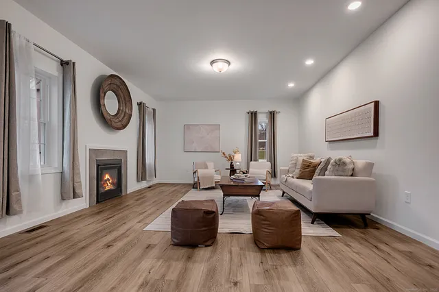 a living room with furniture and a fireplace