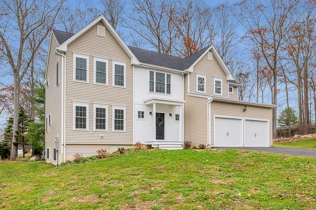 a front view of a house with a garden