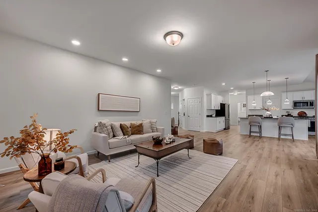 a living room with furniture and kitchen view