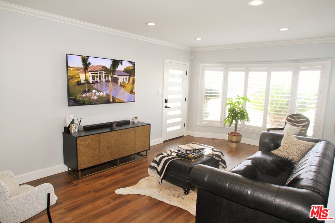 1712 West Poplar Street Compton, CA 90220 - Photo 1 of 41 a living room with furniture and a flat screen tv