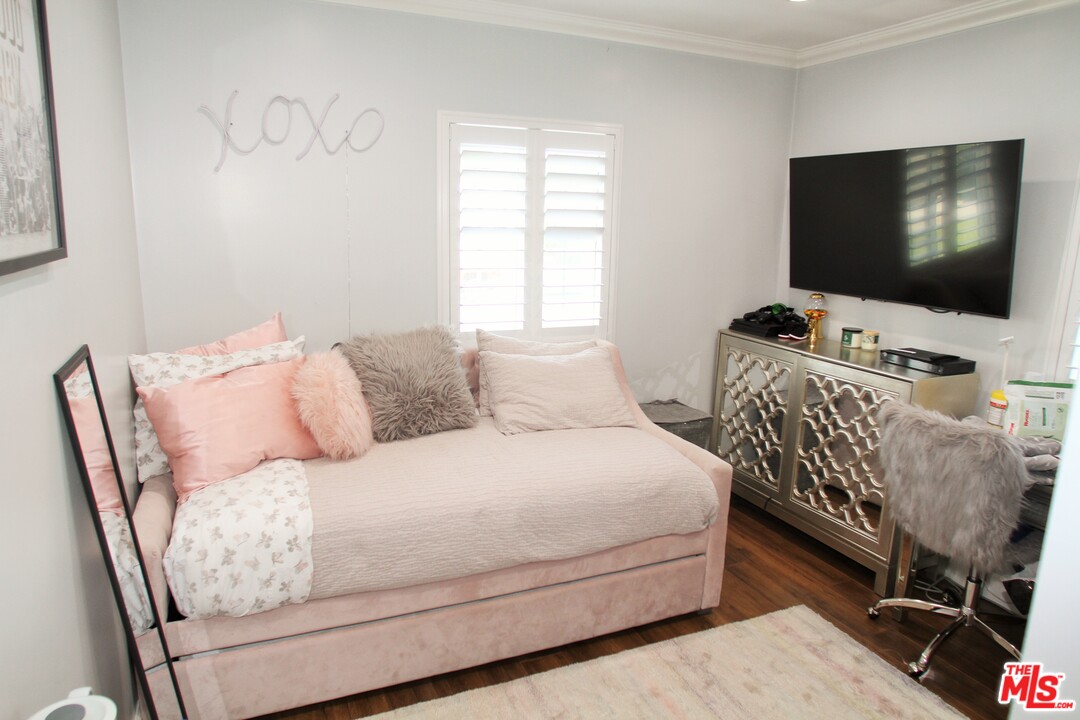 1712 West Poplar Street Compton, CA 90220 - Photo 15 of 41 a bedroom with a bed and a flat screen tv