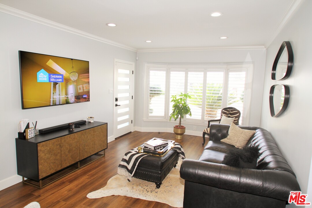 1712 West Poplar Street Compton, CA 90220 - Photo 3 of 41 a living room with furniture and a flat screen tv