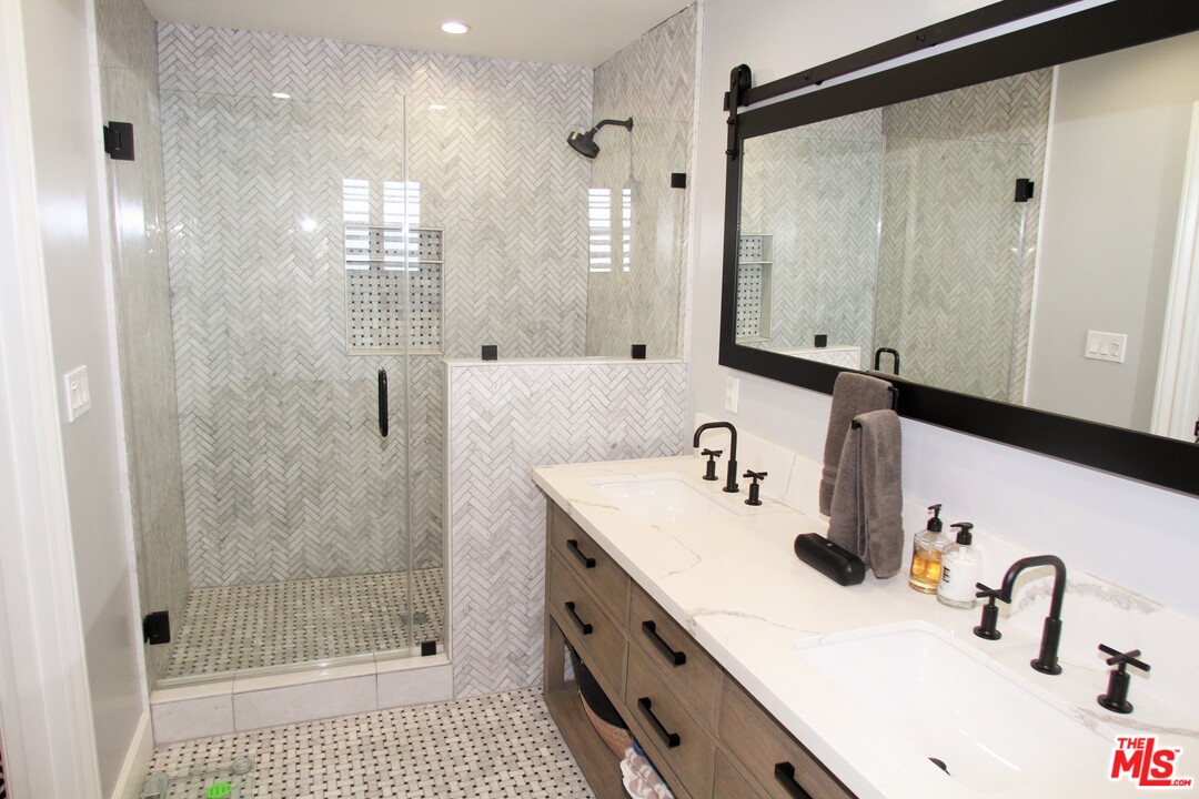 1712 West Poplar Street Compton, CA 90220 - Photo 22 of 41 a bathroom with a sink a toilet a mirror and shower