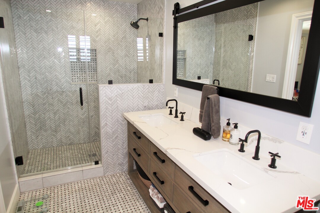 1712 West Poplar Street Compton, CA 90220 - Photo 23 of 41 a bathroom with a shower sink and mirror