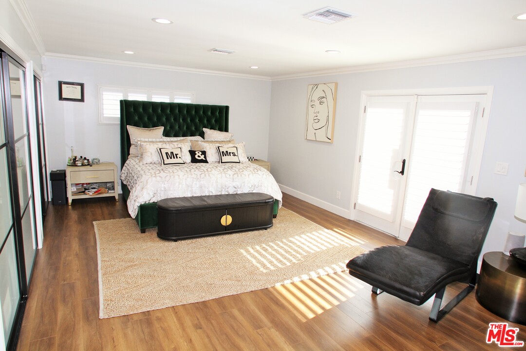 1712 West Poplar Street Compton, CA 90220 - Photo 27 of 41 a bed sitting in a bedroom and chair