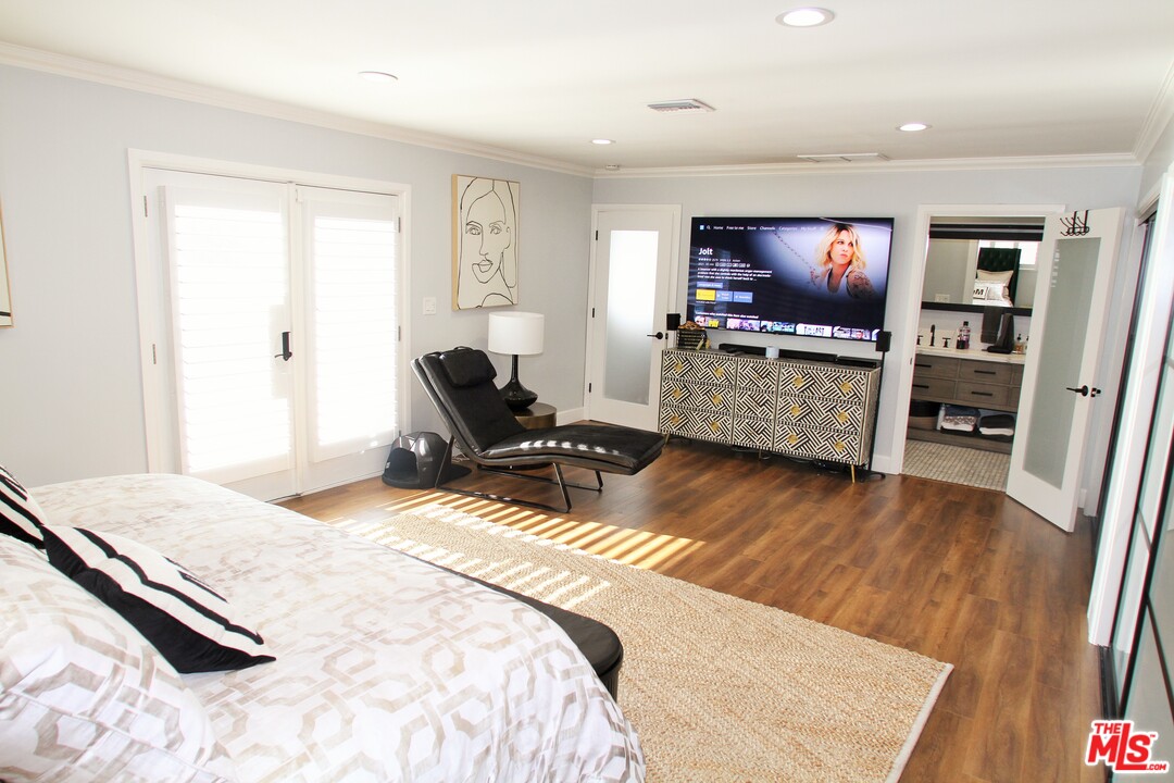 1712 West Poplar Street Compton, CA 90220 - Photo 28 of 41 a bedroom with a bed and a flat screen tv