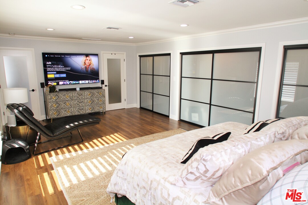 1712 West Poplar Street Compton, CA 90220 - Photo 29 of 41 a bedroom with a bed and a flat screen tv