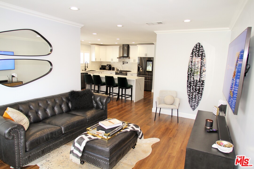 1712 West Poplar Street Compton, CA 90220 - Photo 4 of 41 a living room with furniture and wooden floor