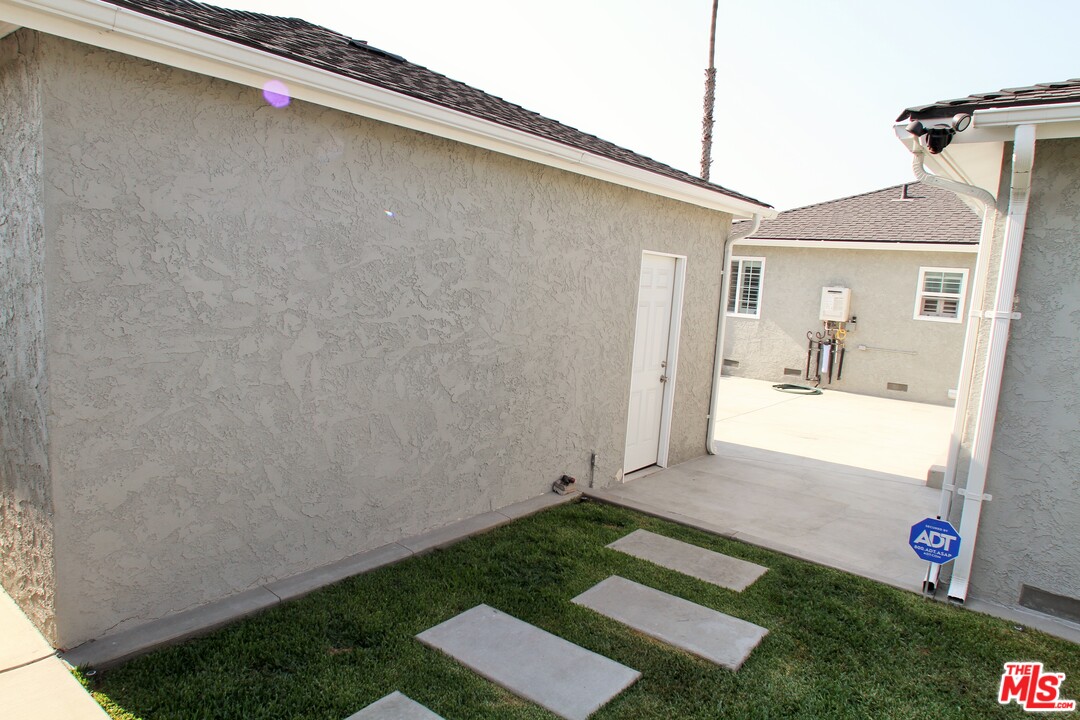 1712 West Poplar Street Compton, CA 90220 - Photo 32 of 41 a front view of a house with garden
