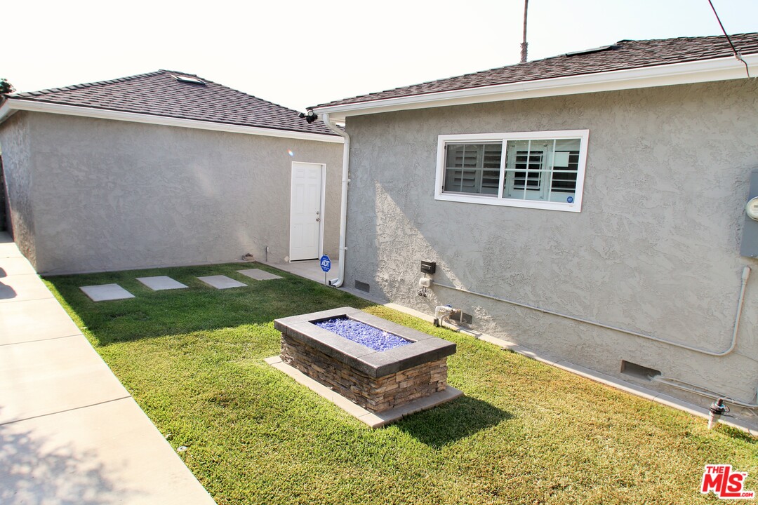 1712 West Poplar Street Compton, CA 90220 - Photo 36 of 41 a backyard of a house with chairs and table