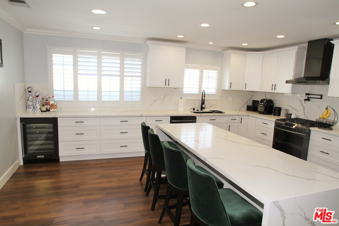 1712 West Poplar Street Compton, CA 90220 - Photo 8 of 41 a kitchen with a sink a window and appliances