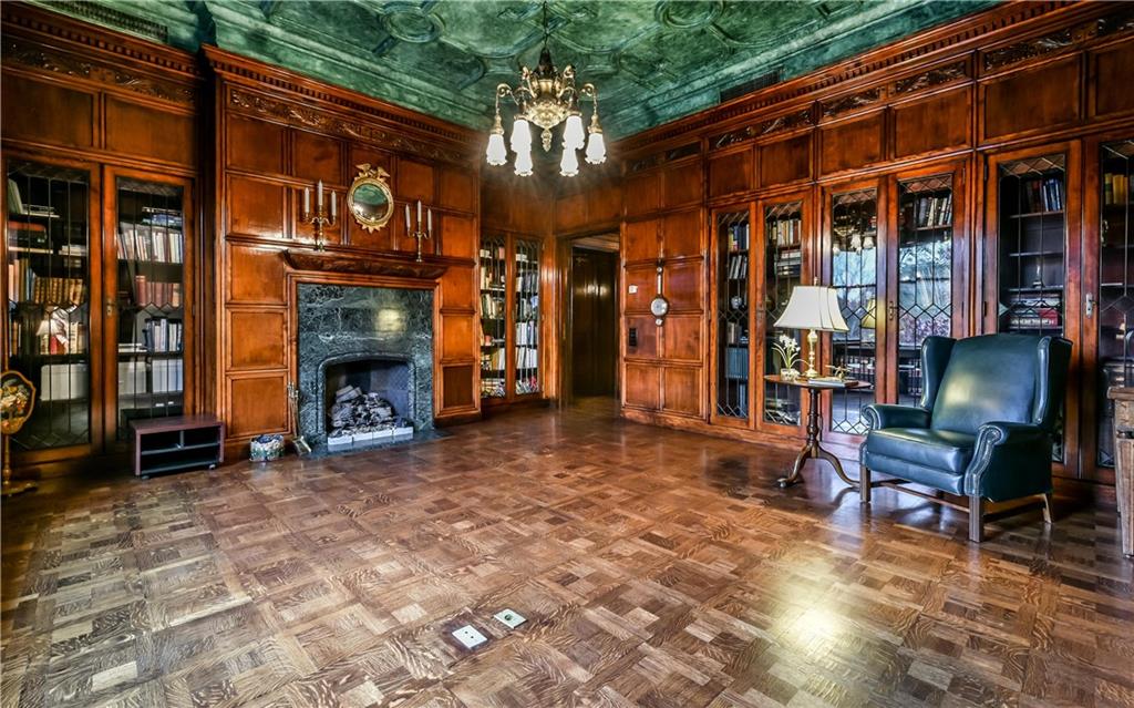 300 North Woodland Road, Unit 2A Pittsburgh, PA 15232 - Photo 18 of 25 Beautiful living room/library with incredible woodwork and hardwood flooring, built in book shelves, gas fireplace.