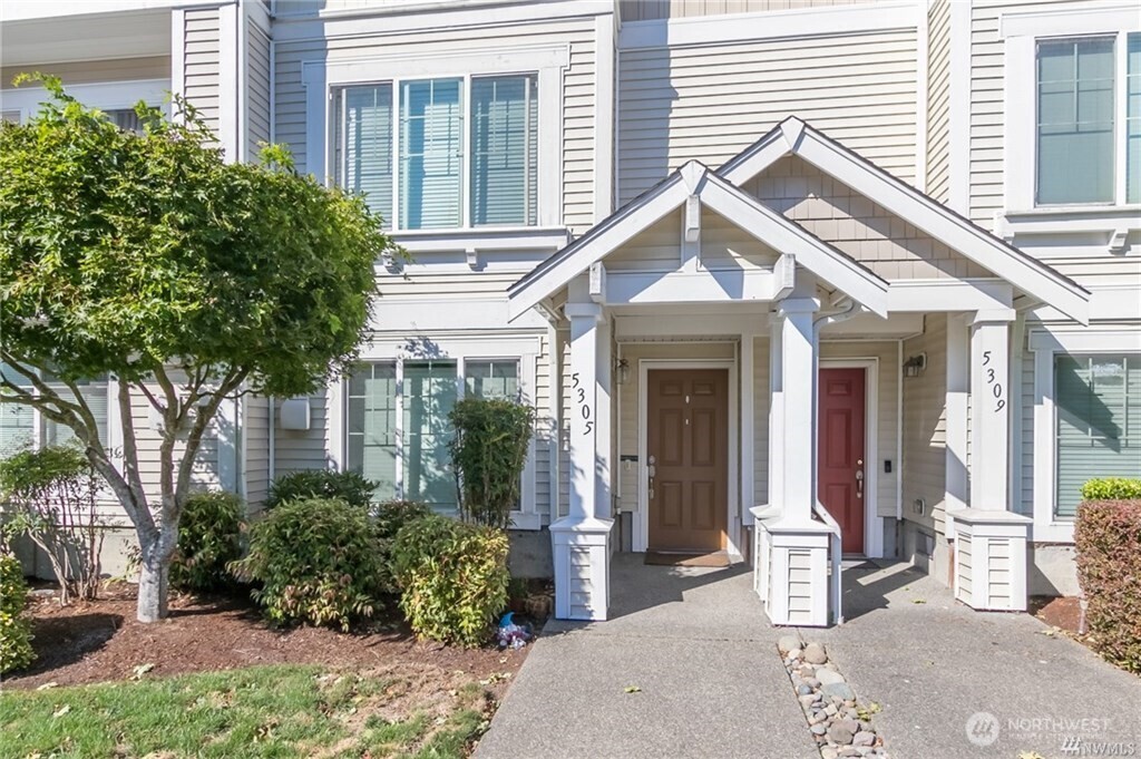 a view of a house with brick walls and potted plants