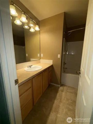 wooden floor in an empty room with a kitchen