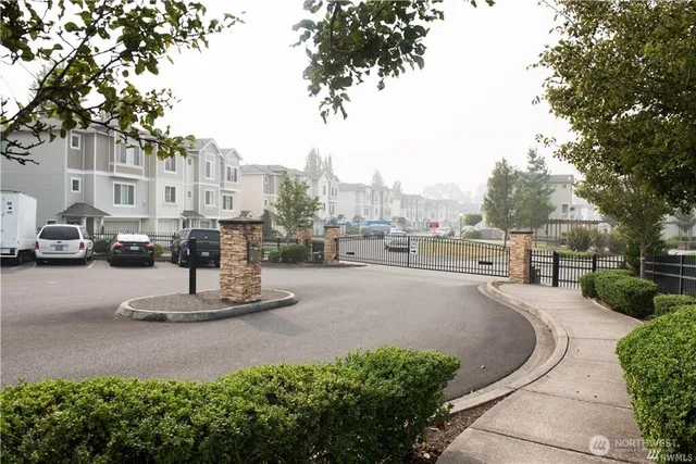 a view of a street with a cars park side of a road