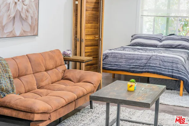 a bedroom with furniture and a wooden floor