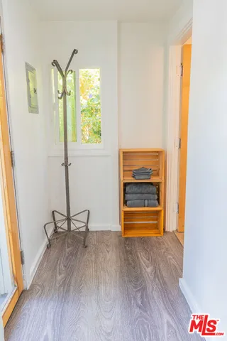 a view of room with window and wooden floor