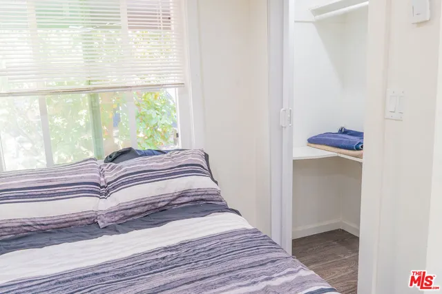 a bedroom with a bed and a window