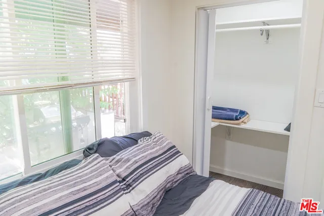 a bedroom with a bed and a window with outer view
