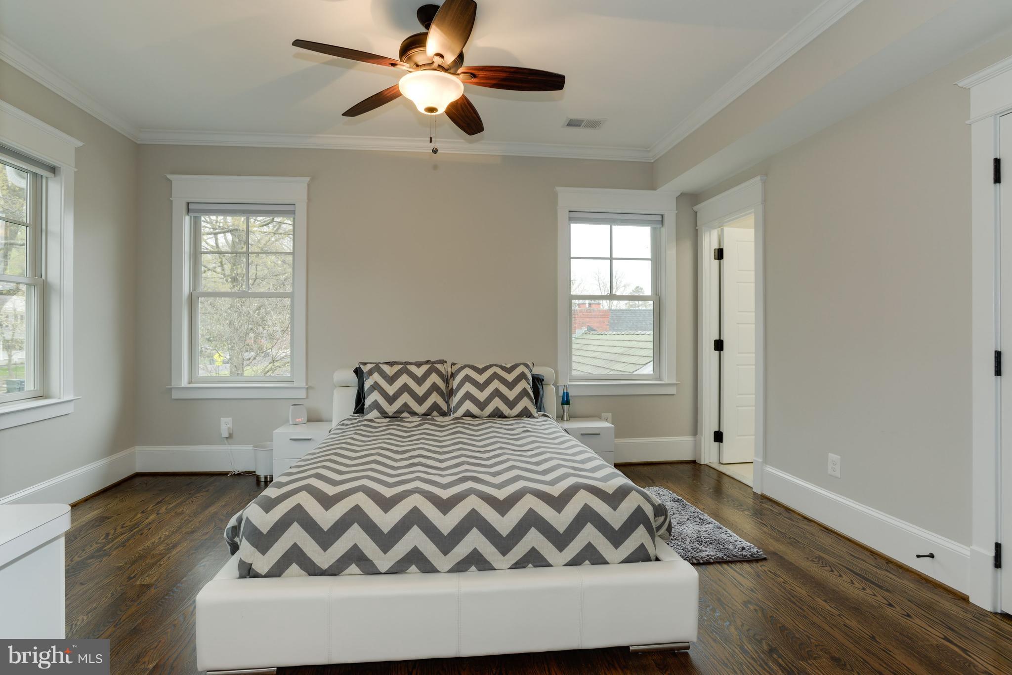 5836 MacArthur Boulevard Northwest Washington, DC 20016 - Photo 19 of 29 a bedroom with a bed and wooden floor